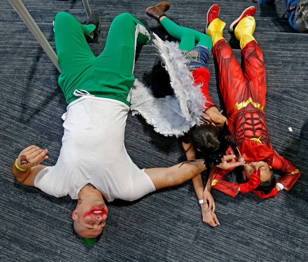 Isaac Planty, dressed as Joker, left, and his son Israel, 9, and daughter Isabelle, 11, take...