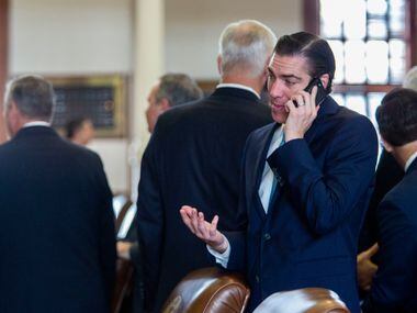 State Rep. Morgan Meyer chats on the phone while on the House floor just before Sine Die at...