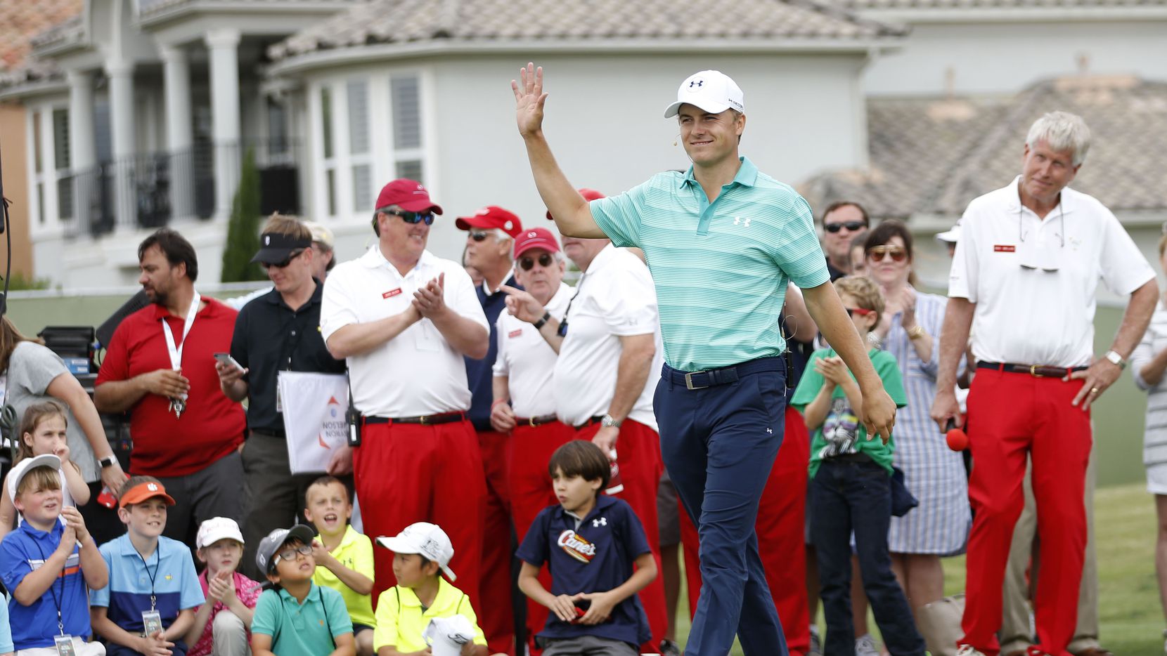 Jordan Spieth waves to the crowd as he is introduced  during a youth golf clinic at TPC Four...