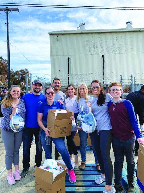 Team members from David Weekley Homes donated 7,580 pounds of Thanksgiving food items to the...