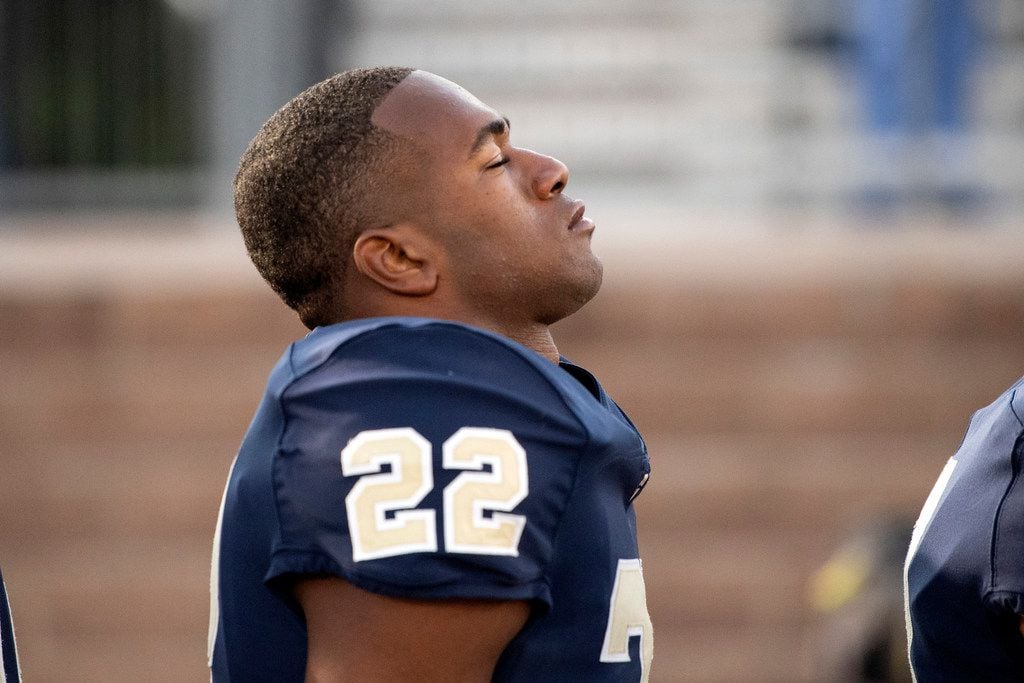 Jesuit senior running back EJ Smith (22) enjoys a moment of peace during a pregame prayer before a high school football game against Prosper on Friday, October 11, 2019 at Postell Stadium in Dallas. (Jeffrey McWhorter/Special Contributor)