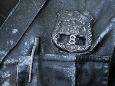 The bronze cop wears a New Jersey badge.