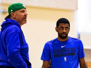 Dallas Mavericks guard Kyrie Irving (right) looks on with head coach Jason Kidd during a...