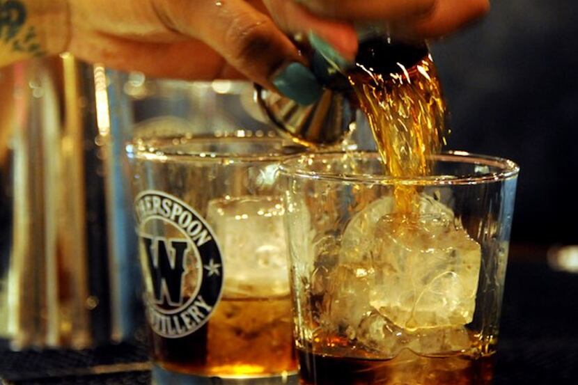 Bourbon is poured for a specialty cocktail at Witherspoon Distillery in Lewisville, TX on...