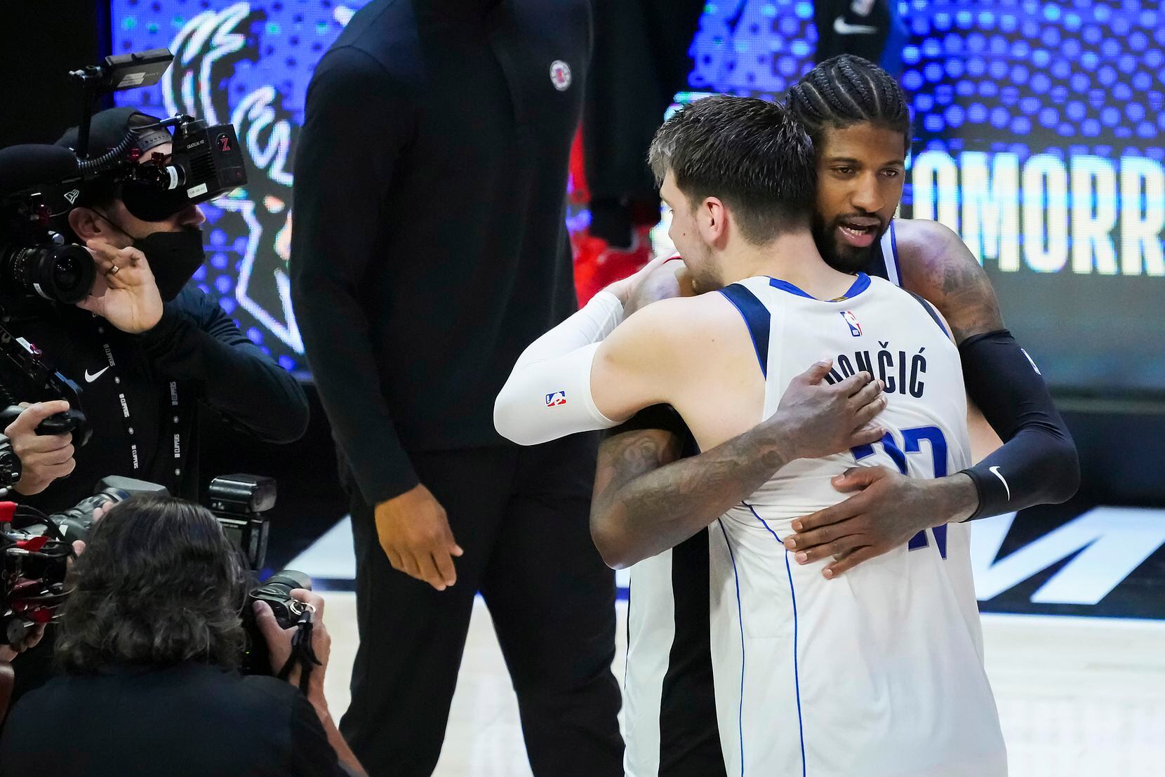Dallas Mavericks guard Luka Doncic (77) hugs LA Clippers guard Paul George after the...