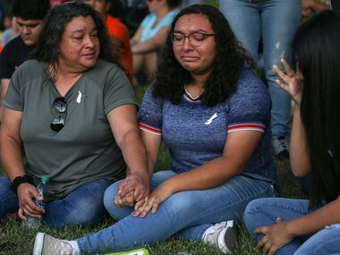 Christina Lopez (from left) comforts her daughter, Celia Lopez, 15, and Sajeili Carrasco,...