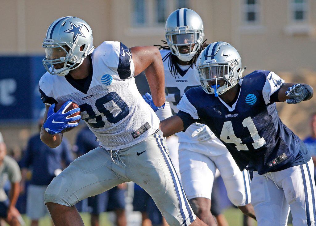 Dallas Cowboys tight end Rico Gathers (80) gets away from a tackle by linebacker Kyle Queiro...