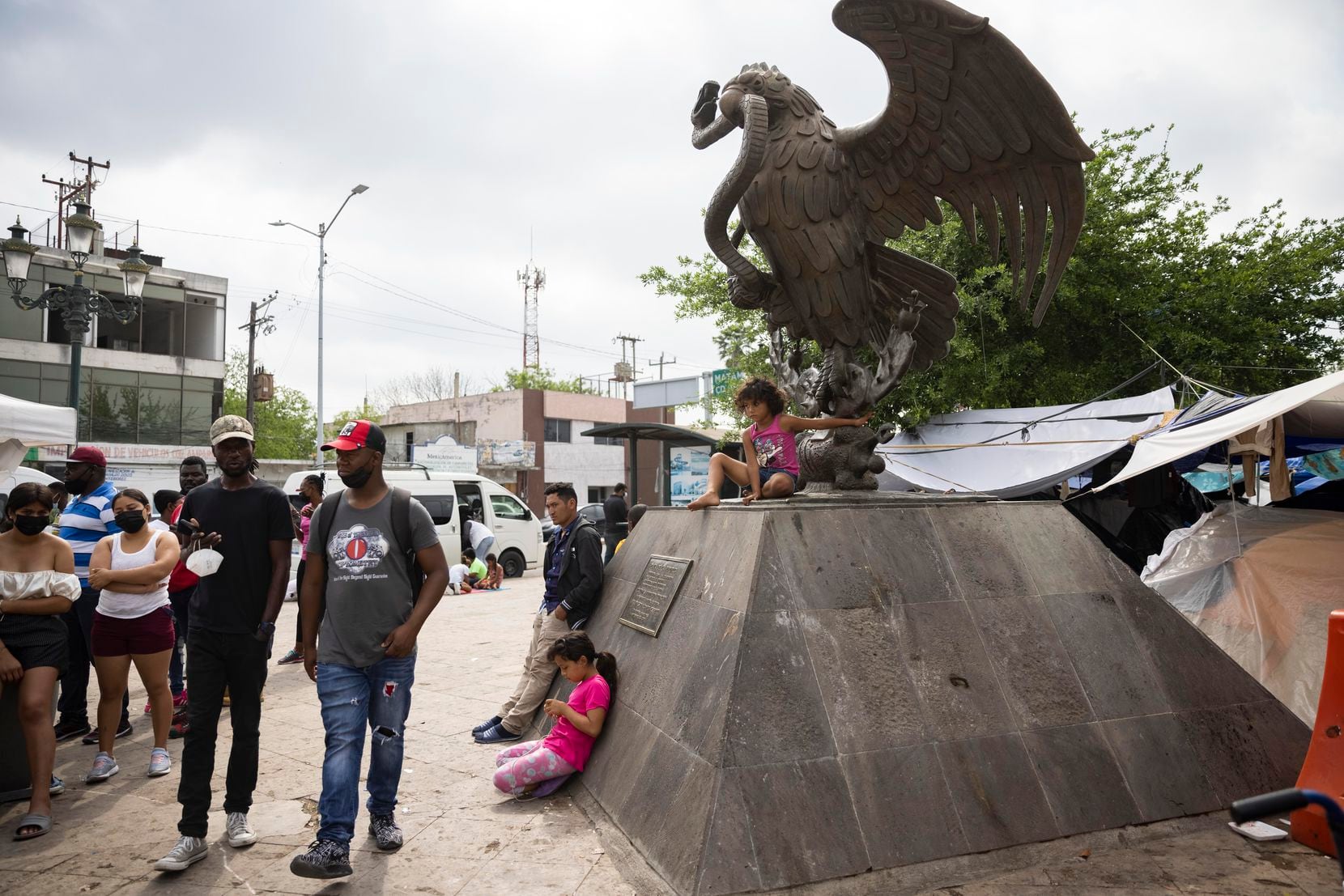 Migrants at Plaza de la República, a public square in the Mexican border city of Reynosa,...