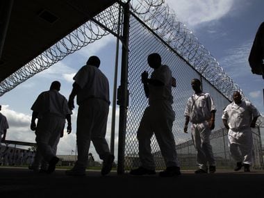 A photo taken July 16, 2014, shows inmates walking to the Chow Hall at the L.V. Hightower Unit in Dayton. Hightower is one of the many state-run jails and prisons that does not have air conditioning installed in inmate housing areas. (AP Photo/Houston Chronicle, Mayra Beltran)
