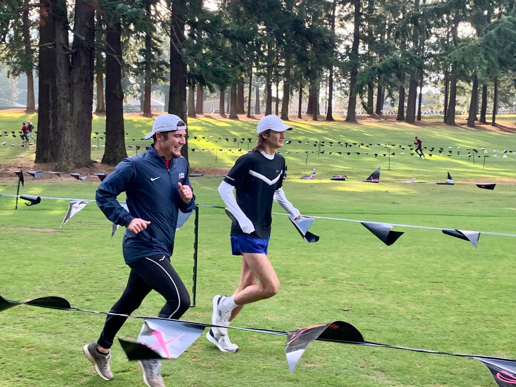 Trace Greer helps his brother Judson warm up for the 2019 Nike Cross Nationals. Judson, a...