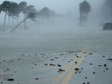 A car sits abandoned in storm surge along North Fort Lauderdale Beach Boulevard as Hurricane...