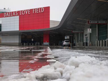 Ice sits along the curbside of Dallas Love Field Airport in Dallas on Wednesday, Feb. 1,...