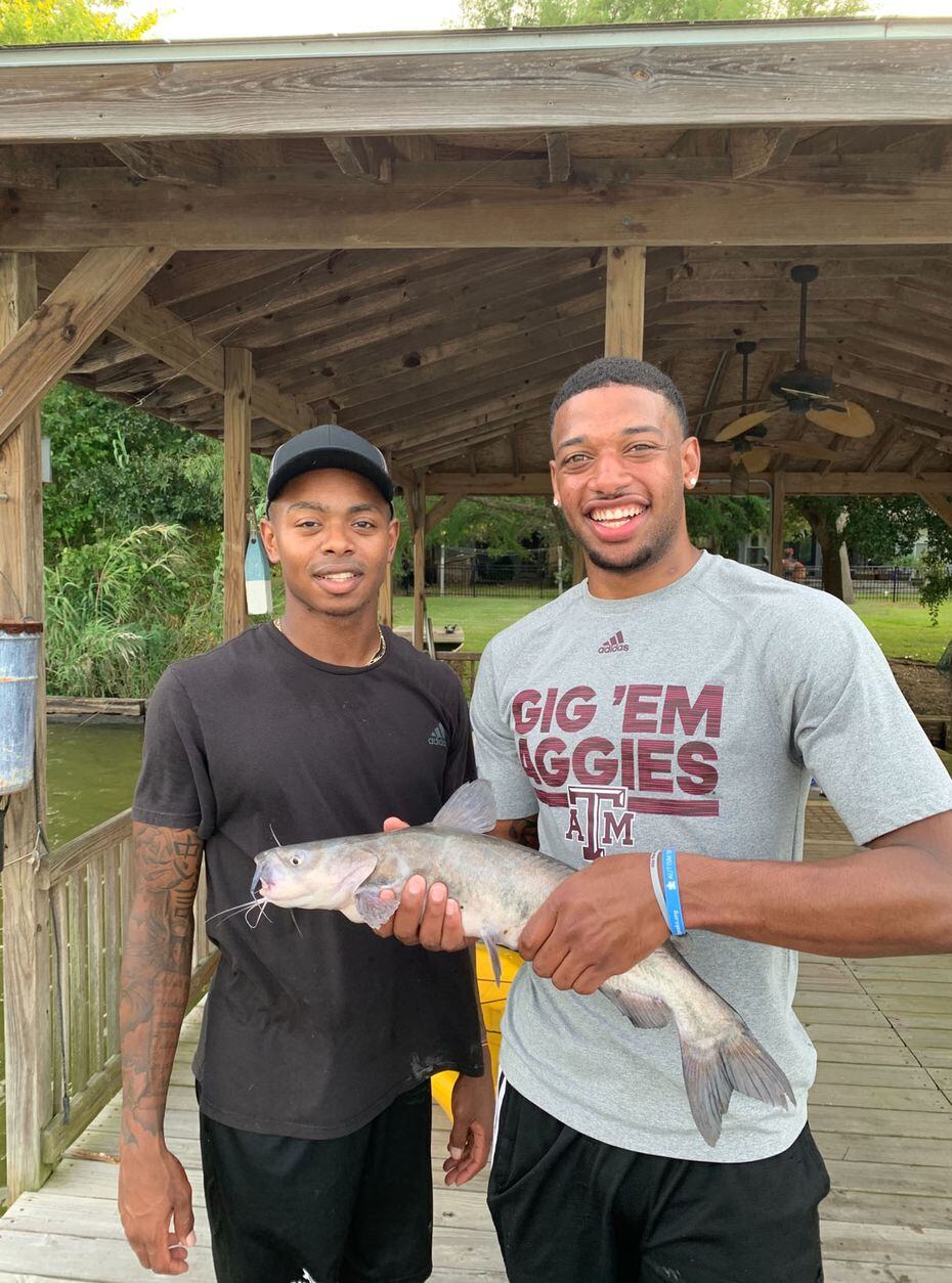 Texas A&M's Wendell Mitchell (left) and teammate Savion Flagg (right) show off their catch...