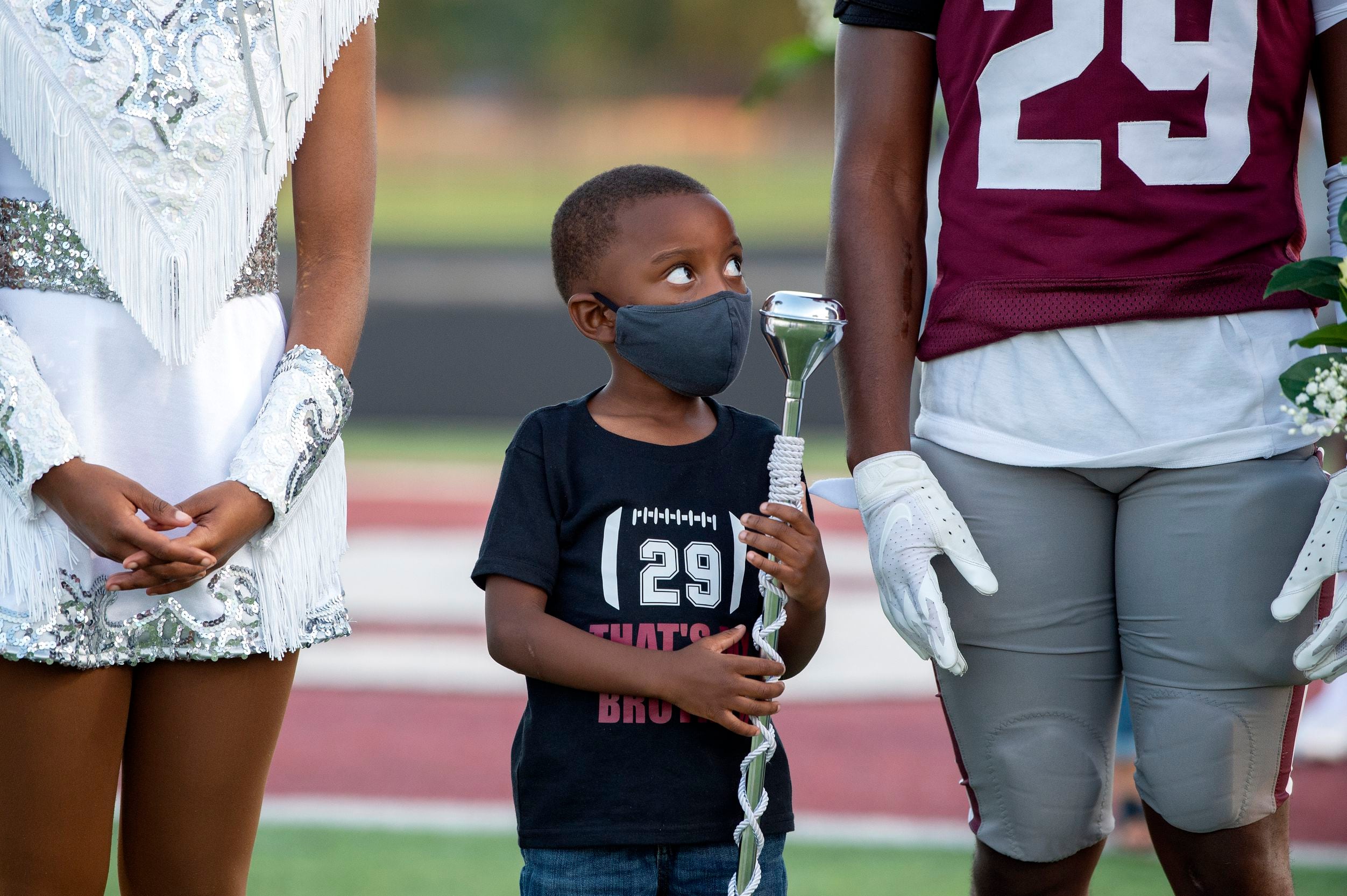 Kinsey Williams, 5, stands between his siblings, Sania and Devon Robison, during Red Oak’s...