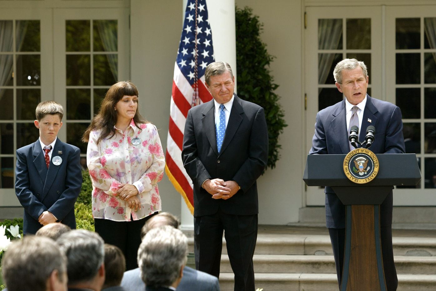 President George W. Bush speaks before signing Amber Alert legislation into law during a Rose Garden ceremony at the White House on Wednesday, April 30, 2003. The law creates a nationwide voluntary rapid-response network to help find kidnapped children. Bush is joined by Attorney General John Ashcroft, center, and Donna Norris, second from left, the mother of the bill's namesake, 9-year-old Amber Hagerman who was abducted in 1996 in Arlington, Texas, and later found murdered. Her son Rick Hagerman stands at far left.