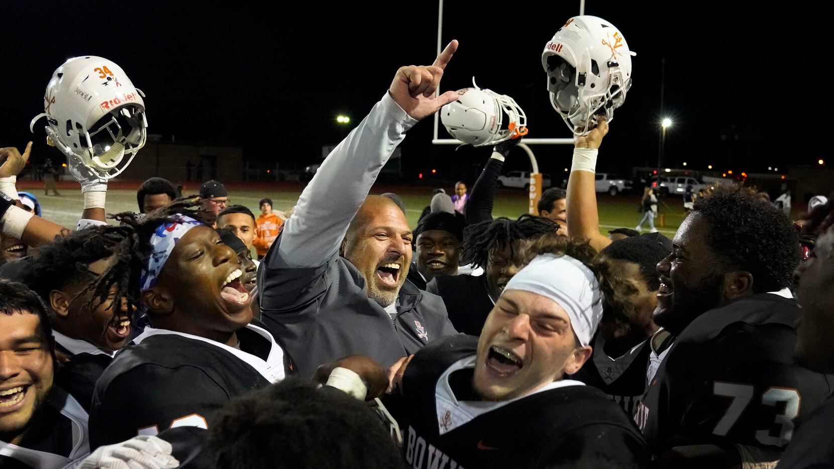 Arlington Bowie head coach Danny DeArman celebrates with his players after a victory over...