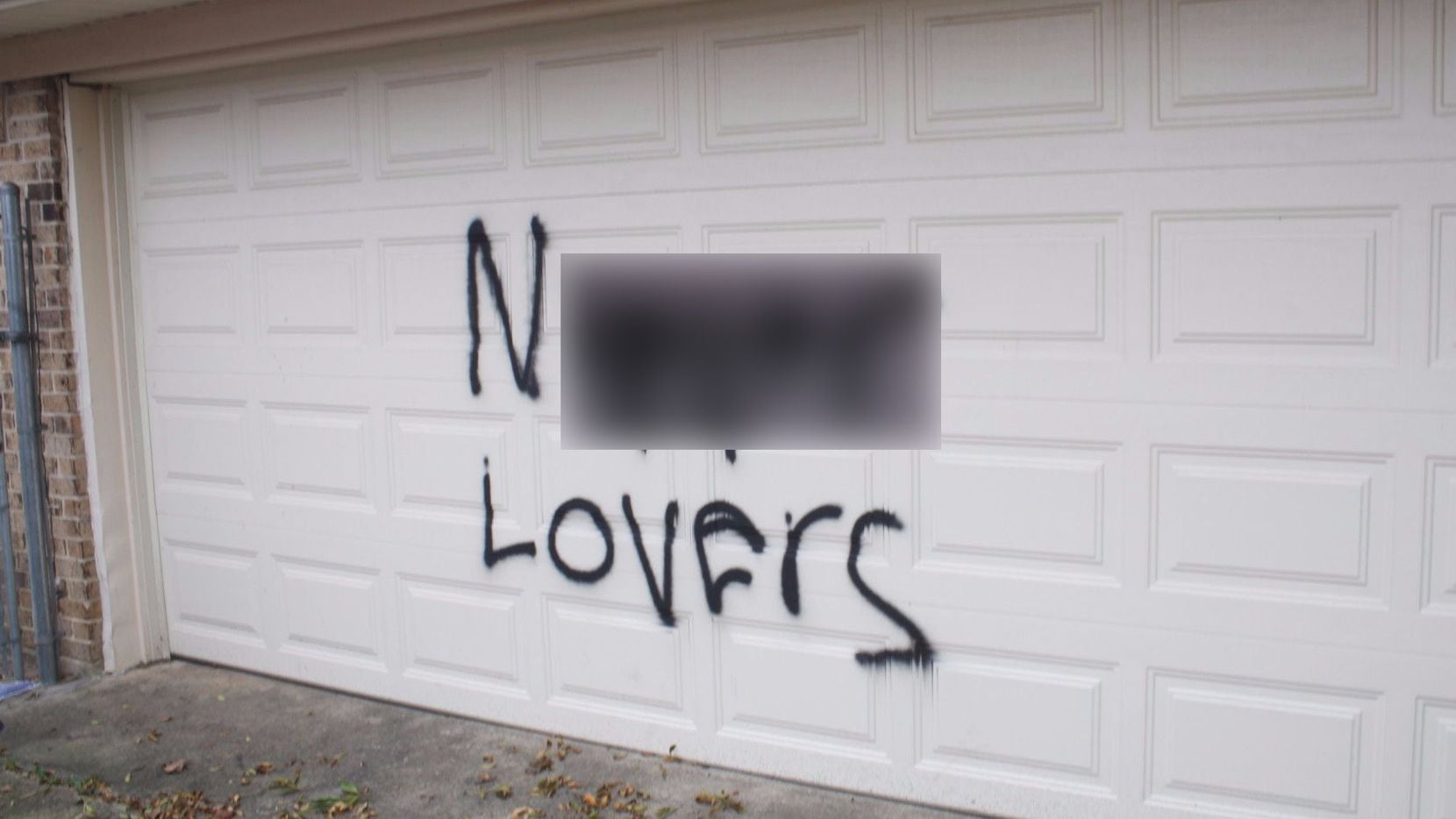 A racial slur was spray-painted on a Denton garage door early Dec. 12. (Julian Gill/Denton...