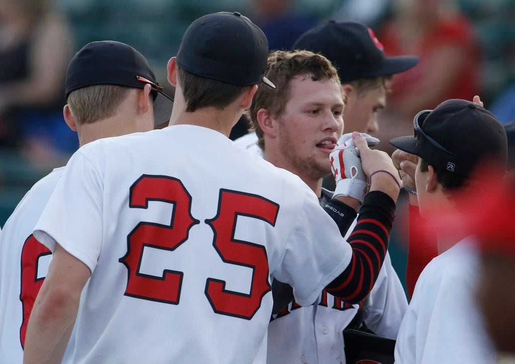 Colleyville Heritage 3rd baseman Mason Greer (16), center, receives congratulations after scoring in the bottom of the 2nd inning against Lubbock Monterey. The two teams played Game 1 of a best-of-3 Class 5A Region 1 final series at Abilene Christian University's Crutcher Scott Field in Abilene on May 31, 2019. (Steve Hamm/ Special Contributor)