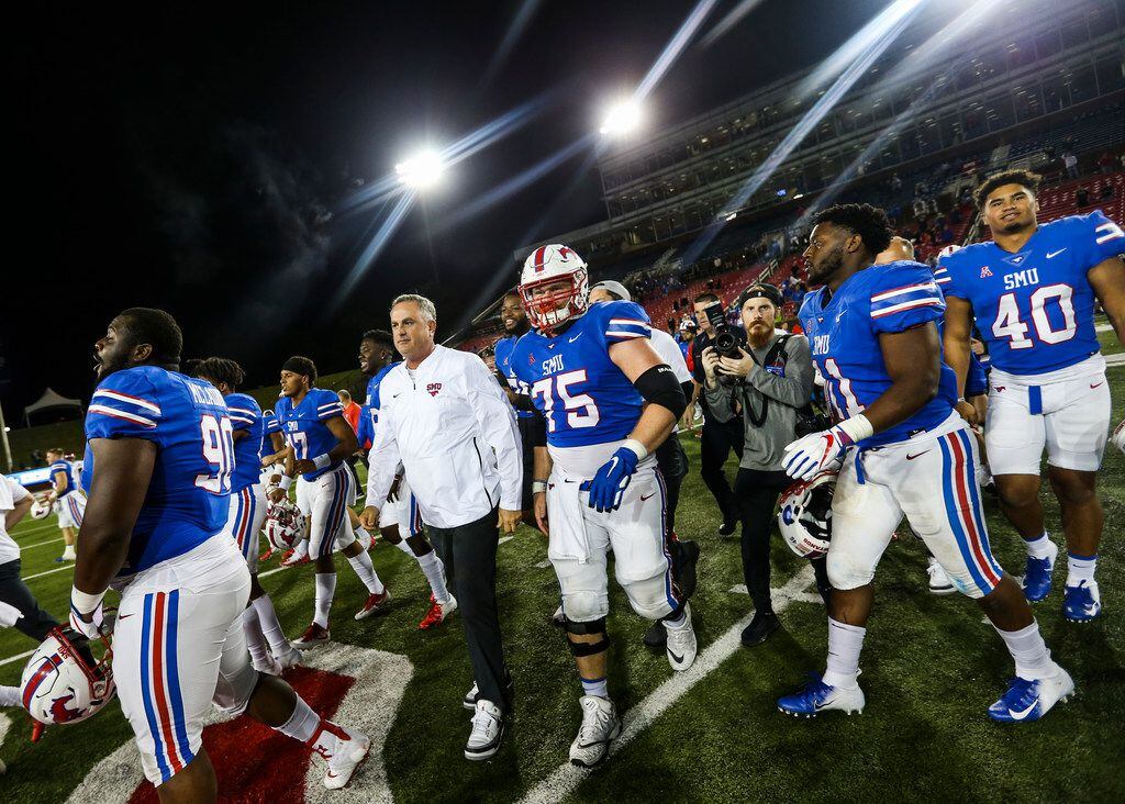 Southern Methodist Mustangs head coach Sonny Dykes makes his way onto the field following a...