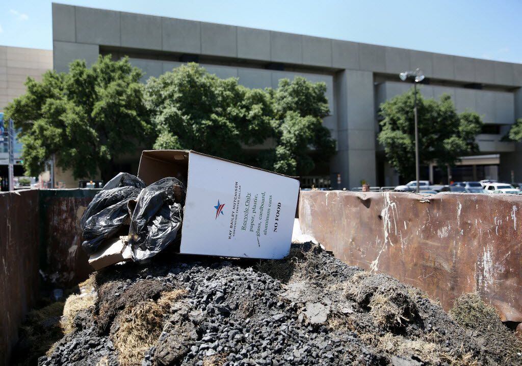  Ashes left over from Thursday night's fire walk were disposed of in a Dumpster at the...