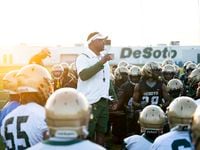 DeSoto football coach Claude Mathis talks to his team before the first practice of the...