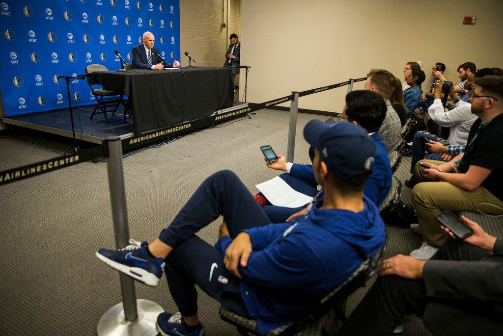 Dallas Mavericks head coach Rick Carlisle speaks to reporters from behind a barrier that is...