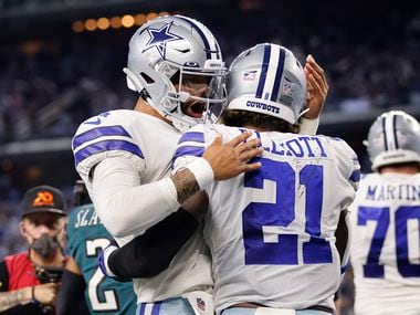Dallas Cowboys quarterback Dak Prescott (4) congratulators running back Ezekiel Elliott (21)...