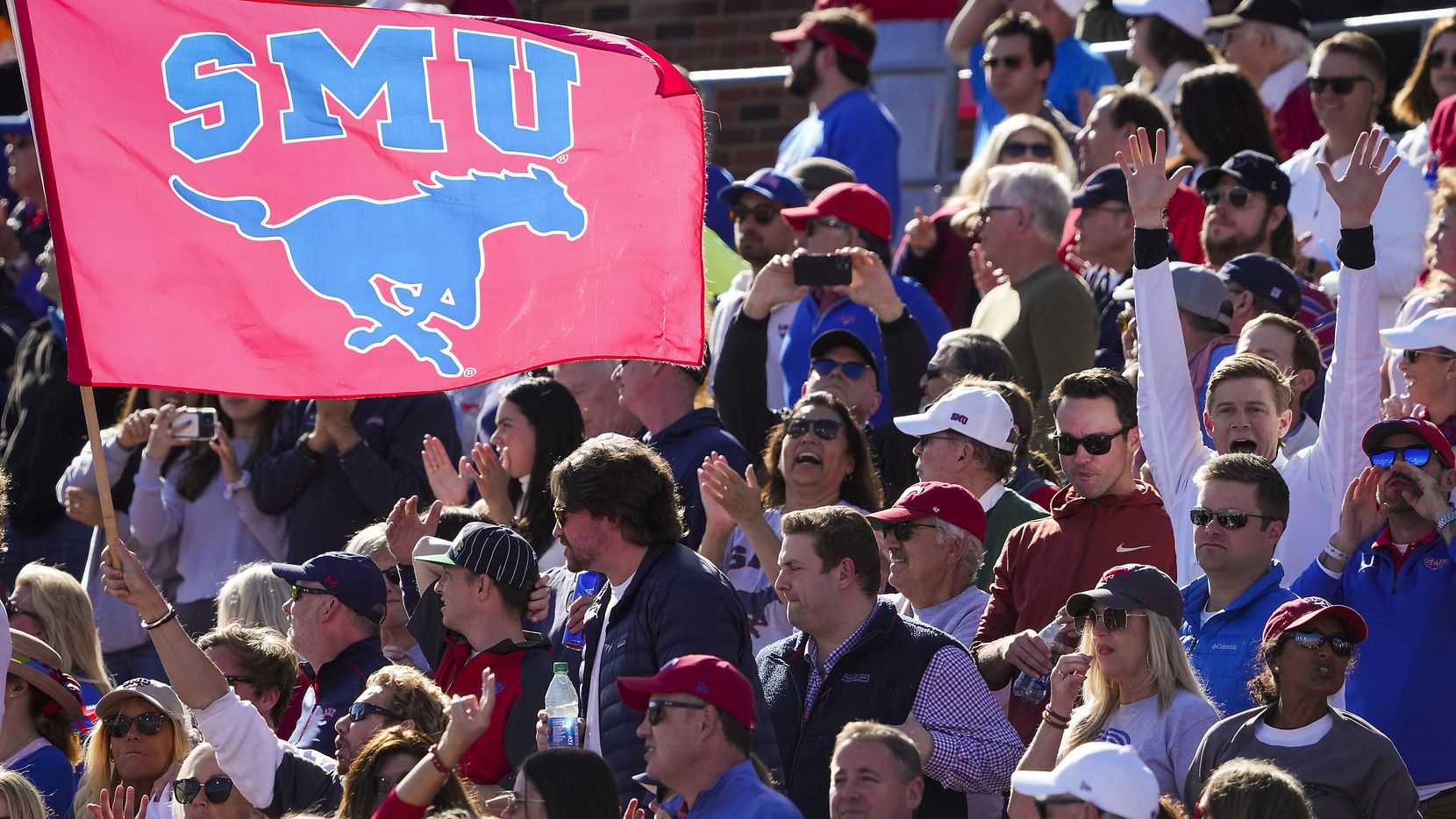 SMU fans celebrate a touchdown catch by wide receiver Reggie Roberson Jr. during the second half of an NCAA football game against UCF at Ford Stadium on Nov. 13, 2021, in Dallas. The Mustangs won the game 55-28.