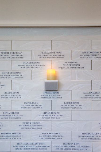 Names of Holocaust victims, survivors and their family members are carved in stone in the...