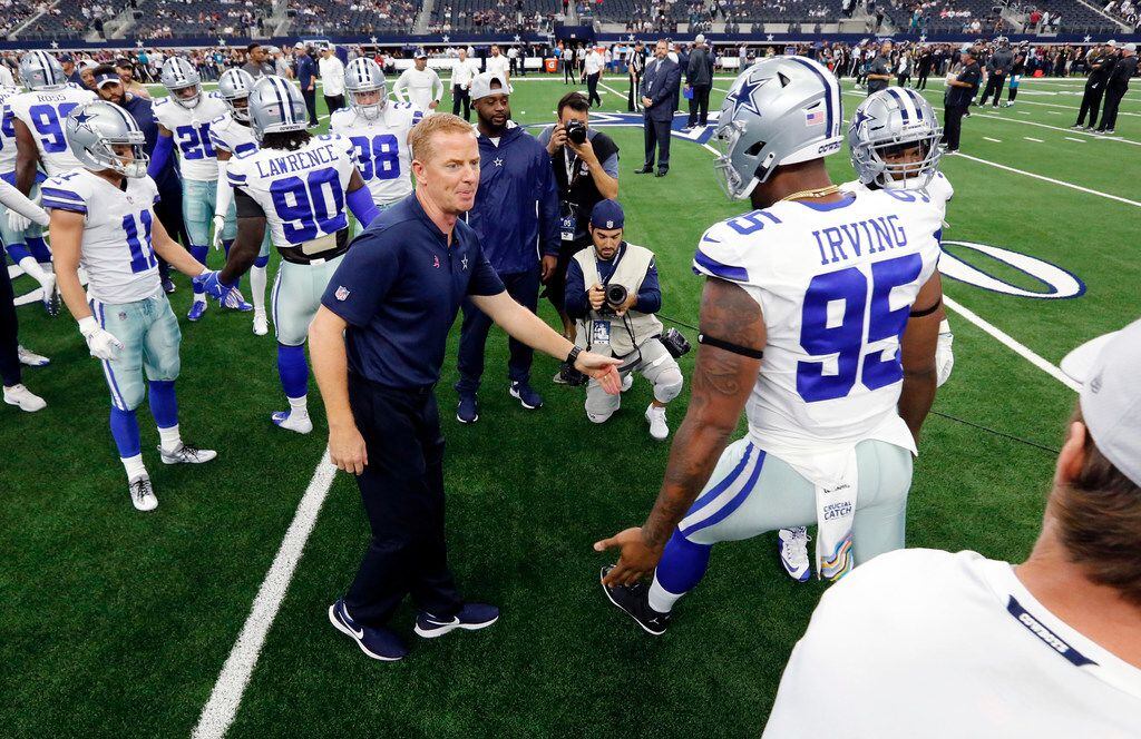Dallas Cowboys head coach Jason Garrett greets defensive tackle David Irving (95) who is...