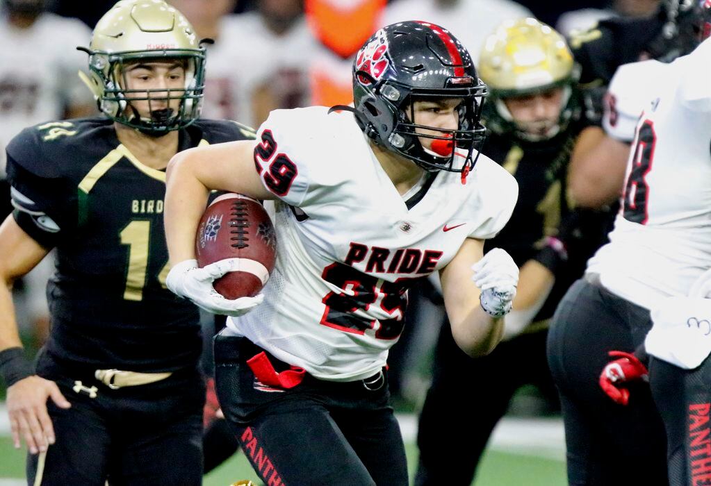 Colleyville Heritage High School running back Braxton Ash (29) carries the ball for a gain...
