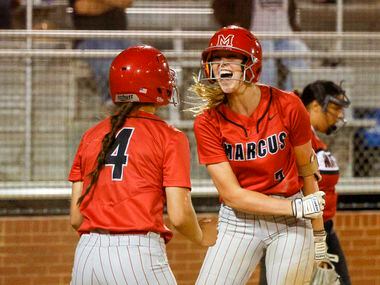 Flower Mound Marcus' Haidyn Sokoloski (right) celebrates her inside-the-park home run with...