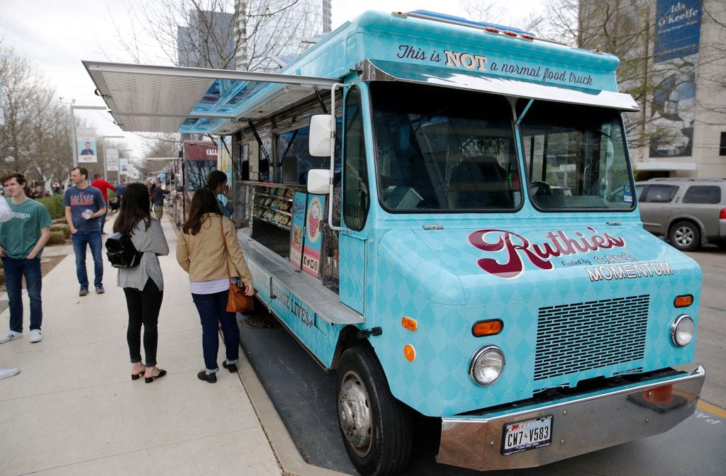 Customers wait to give their order at Ruthie's Rolling Cafe food truck at Klyde Warren Park...