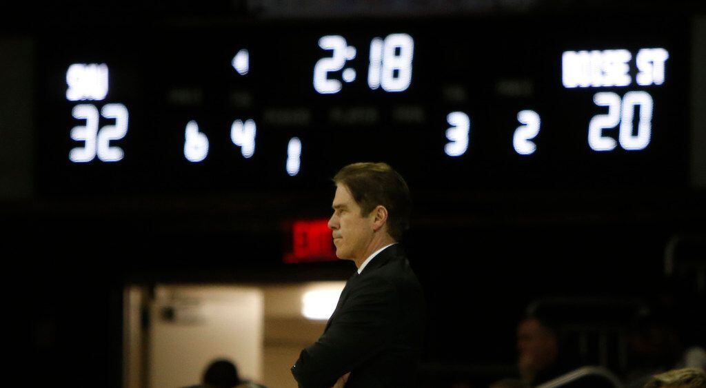 SMU Mustangs head coach Tim Jankovich keeps on eye on the action from the team bench during...
