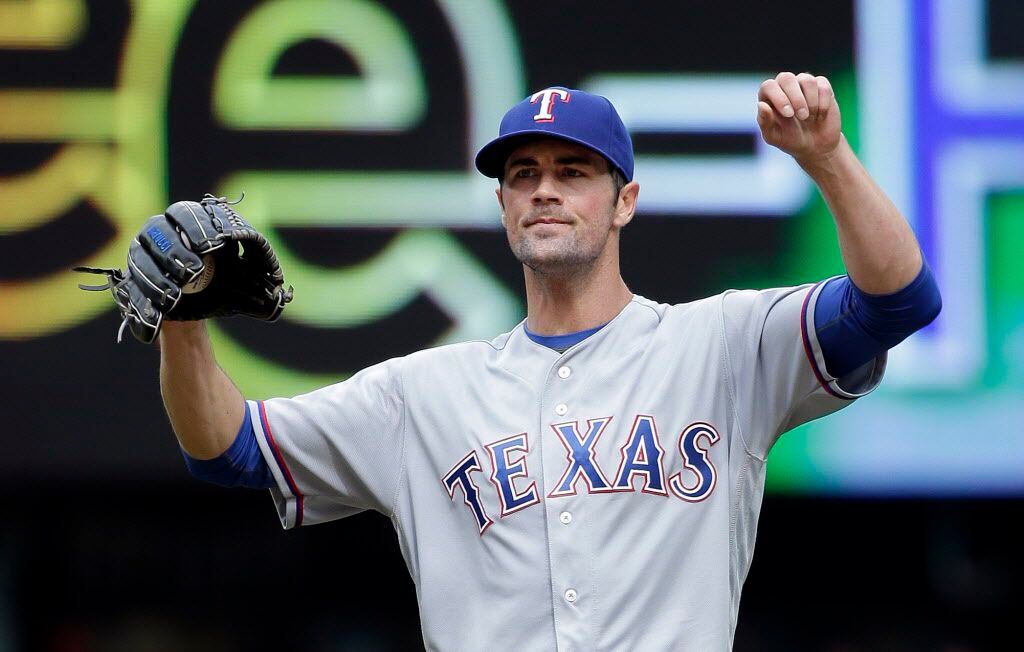 Texas Rangers starting pitcher Cole Hamels stretches after giving up a walk to the Seattle...