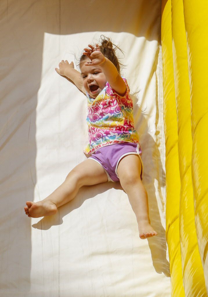Presley Reynolds, 2, yells as she slides down the slide in the Kidz Korner at the...