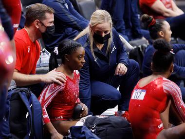 Coaches Laurent Landi (left) and Cecile Landi talk with Simone Biles after she competed on the balance beam during day 2 of the women's 2021 U.S. Olympic Trials at The Dome at America’s Center on Sunday, June 27, 2021 in St Louis, Missouri.
