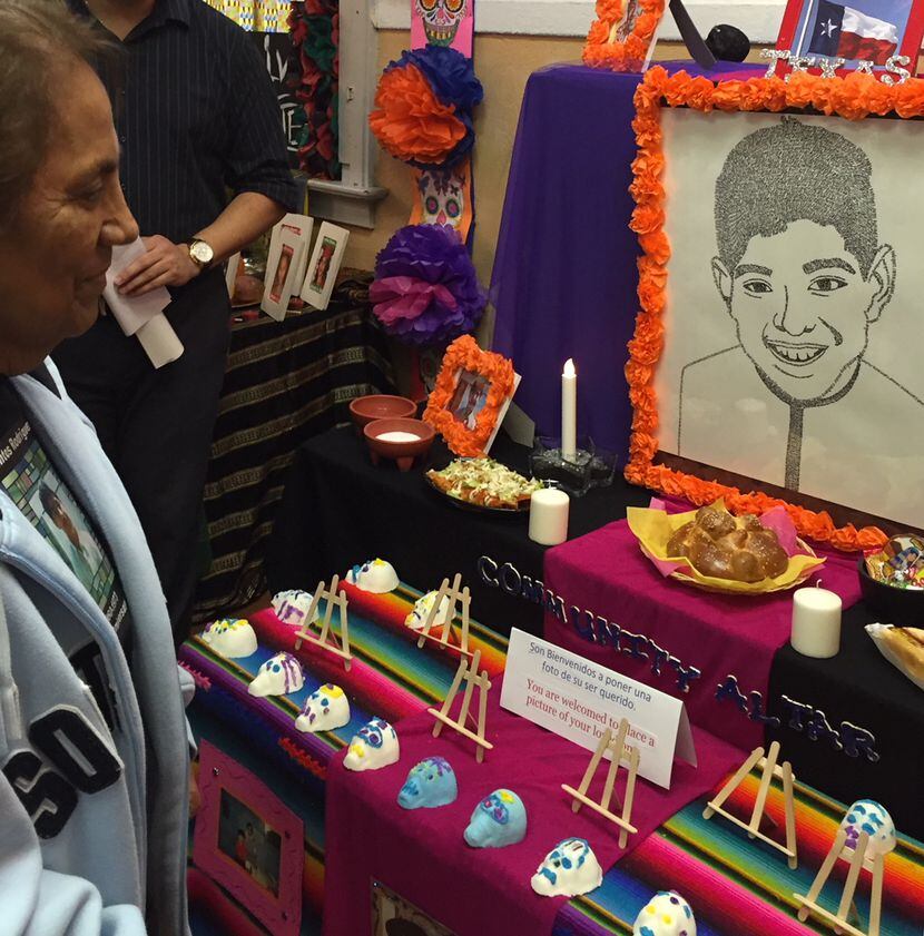 Bessie Rodriguez smiles at a Day of the Dead altar in Seattle, where a small park...