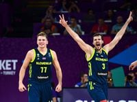 Slovenia's guard Luka Doncic (C) and Goran Dragic (R) celebrate after scoring during the...