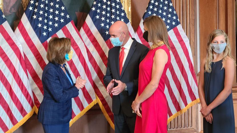 House Speaker Nancy Pelosi chats with newly sworn-in Rep. Jake Ellzey of Ellis County and...