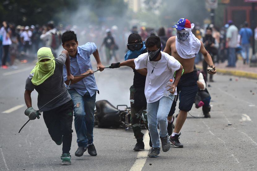 manifestantes se enfrentan con las fuerzas policiales en Caracas, Venezuela.(GETTY IMAGES)
