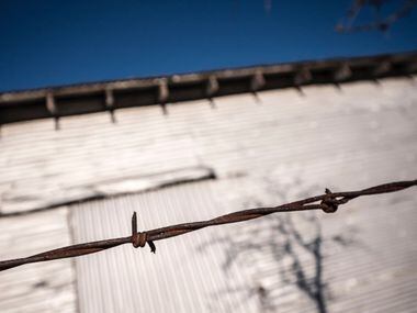 A barbed wire fence alongside a barn on Preston Road near Celina, Texas Feb. 25, 2016.