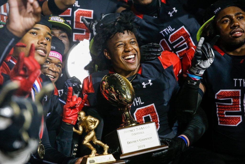 The Cedar Hill Longhorns celebrate their 7-6A district championship win over the DeSoto...