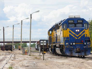A train sits idle on the tracks next to Highway 377 in Cresson.