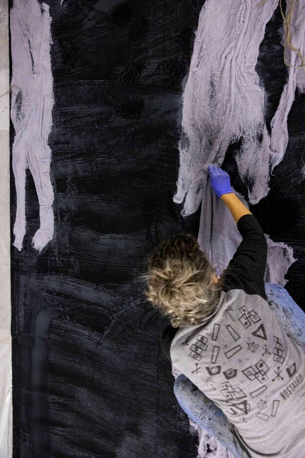Scenic artist Marlowe Hermanoviski uses material such as erosion cloth and string to add...