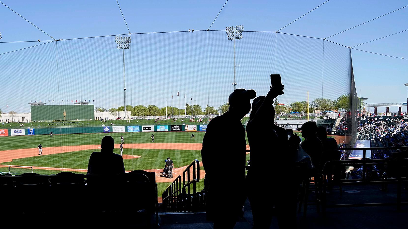Fans take a selfie during the fifth inning of a spring training game between the Texas...