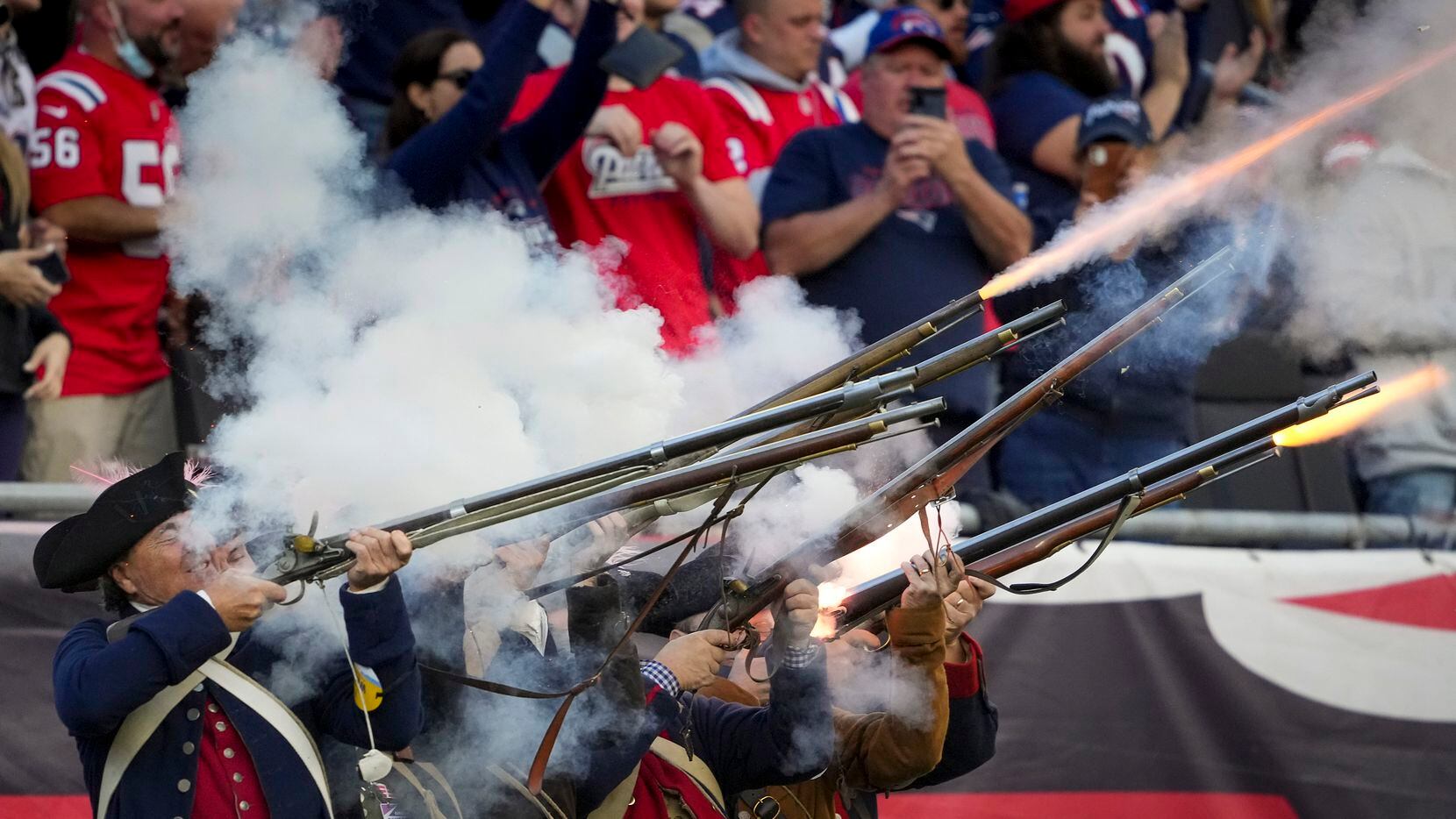 Members of the New England Patriots End Zone Militia fire muskets after a Patriots touchdown...