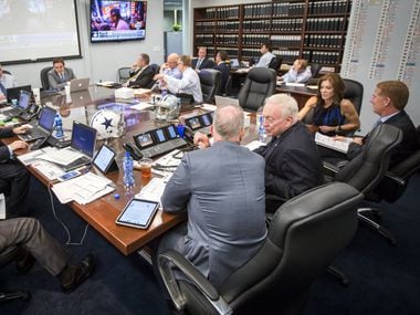Dallas Cowboys owner Jerry Jones (center) talks to his son, executive vice president/COO...