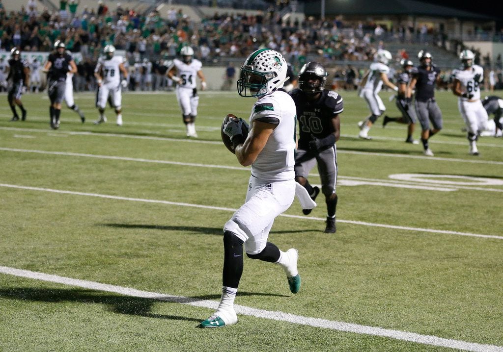 Southlake Carroll's Wills Meyer (5) scores a touchdown in front of Denton Guyer's Zion Settles (10) during the first half of play at C.H. Collins Complex in Denton, on Friday, October 4, 2019. (Vernon Bryant/The Dallas Morning News)