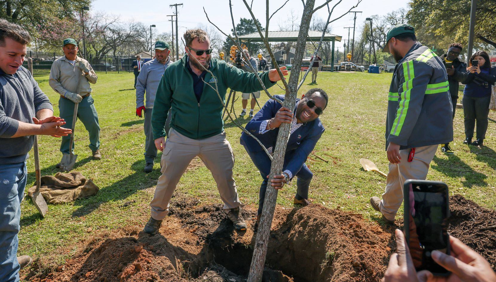 Kirk Myers (right), founder and CEO of Abounding Prosperity Inc., grabs hold of the pecan...